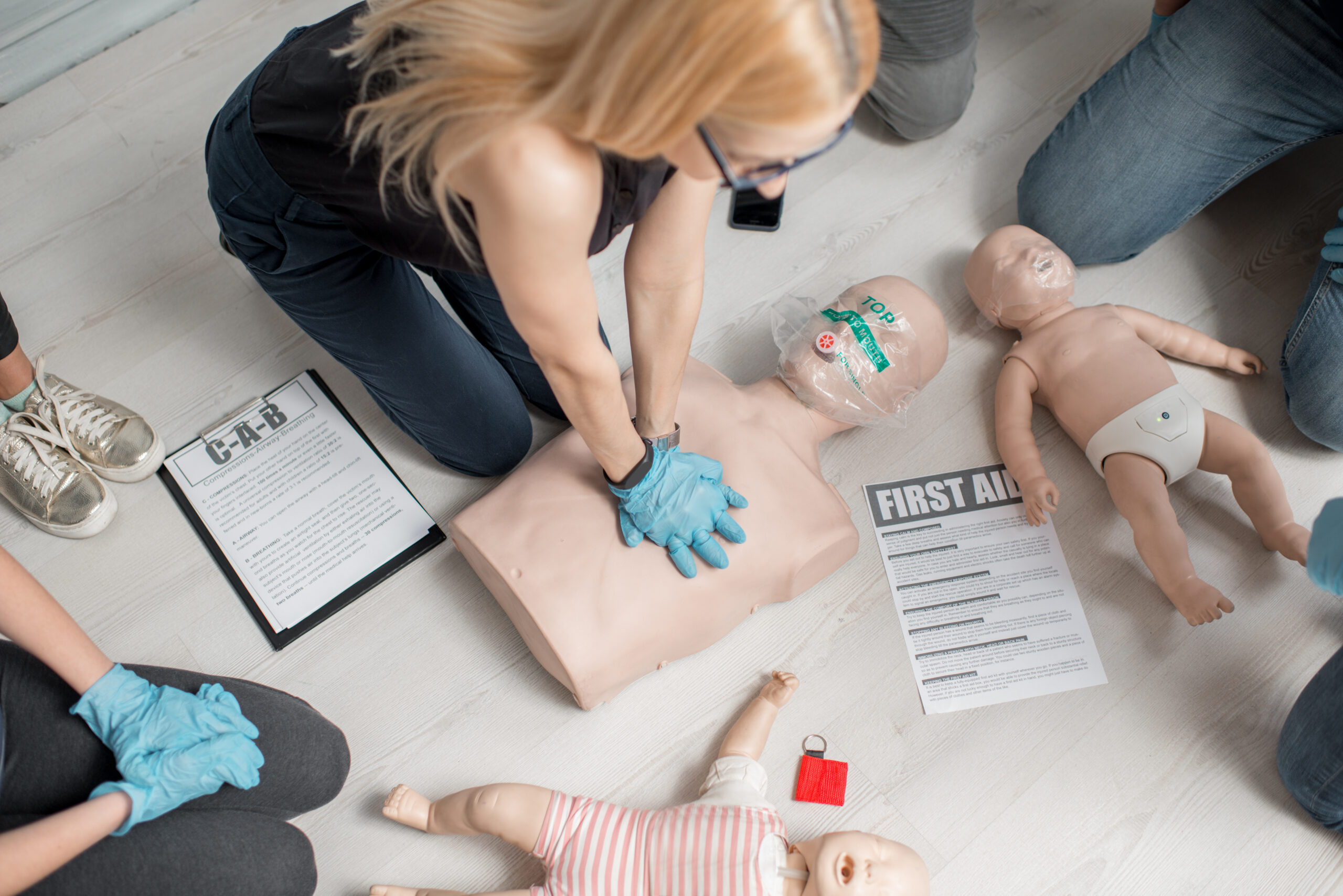 First aid training session with practice mannequins