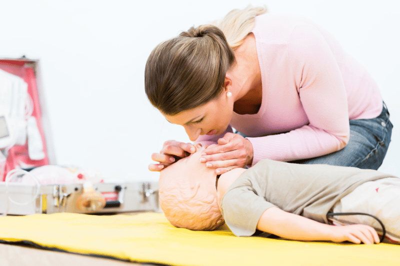 Paediatric first aid practice with a child mannequin